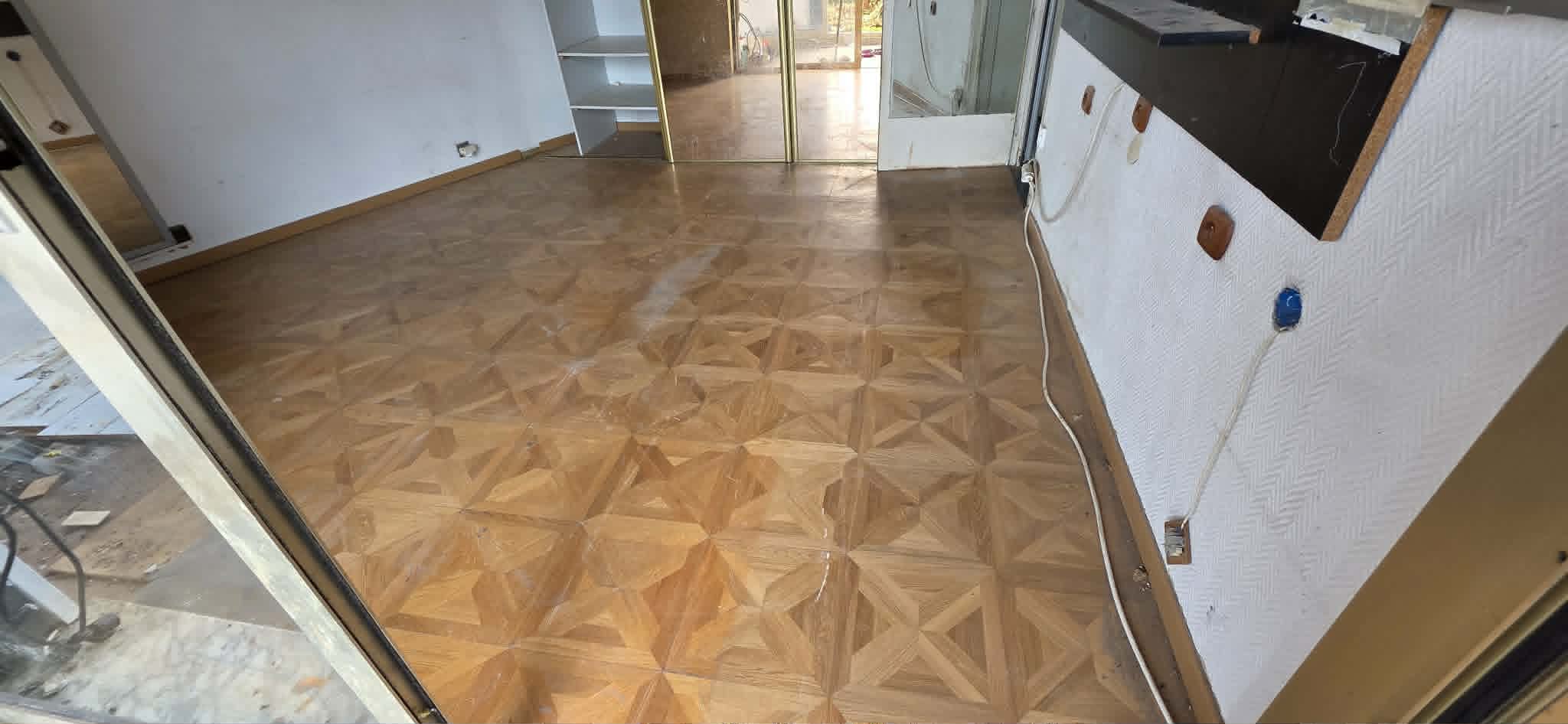Villa living vidé parquet géométrique
